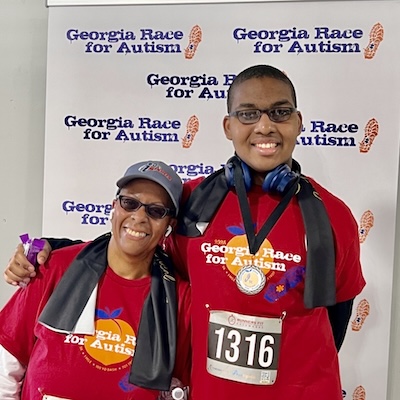 mother and son with race bibs and son has medal